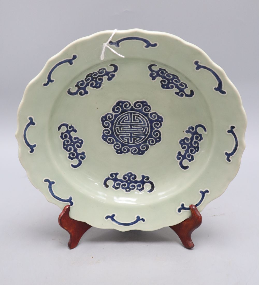 A Chinese celadon glazed bat and shou medallion dish, Qianlong mark but 19th century